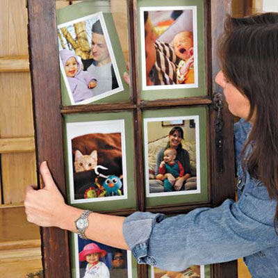 woman arranges the matted photos to the back side of the window
