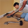 person lever-activated stretcher to demonstrate how-to install carpet