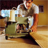person finishing the edges to demonstrate how-to install carpet