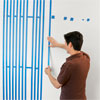 taping the stripes out in order to paint a striped wall