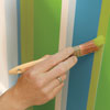 touch up the stripes to finish painting a striped wall