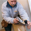 this old house general contractor tom silva using a hand plane to fix a stuck door