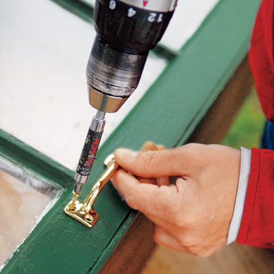 installing the handle to the cold frame lid with a drill/driver