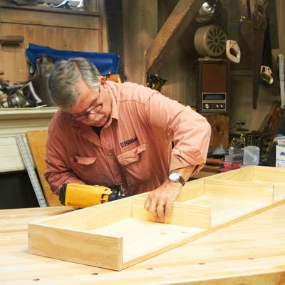 Tom Silva assembles the shelving unit base