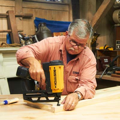 Tom Silva attaches the nailing strips to the top of the shelving unit