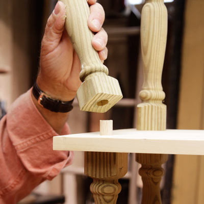 assembling the shelving unit by attaching the spindles