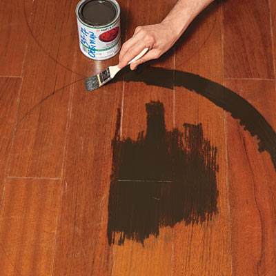 hand painting medallion design on wood floor