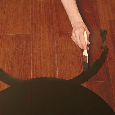 hand painting medallion design on wood floor