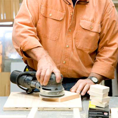 this old house general contractor sanding and painting the pieces to build a freestanding lamp