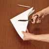 hands cutting out stencil used for wall painting