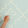 man painting moroccan wall design