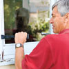 man removing side casings of rotted window sill