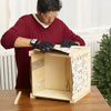 Mark Powers fits the tin squares to the sides of the x-mas tree box stand