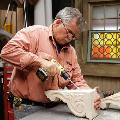 Tom Silva drills a recess into the corbel for a trestle table using a drill/driver with a 5/8-inch paddle bit