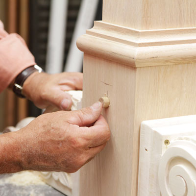 Tom Silva plugs a recess in the table leg for a trestle table with a wood plug made from a 5/8-inch dowel