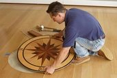 man installing a floor medallion