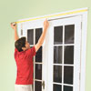 Mark Powers measures the top casing above a set of French doors