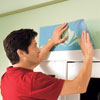Mark Powers positions the top part of the stencil above the casing of the French doors