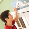 Mark Powers stipples paint into the stencil pattern