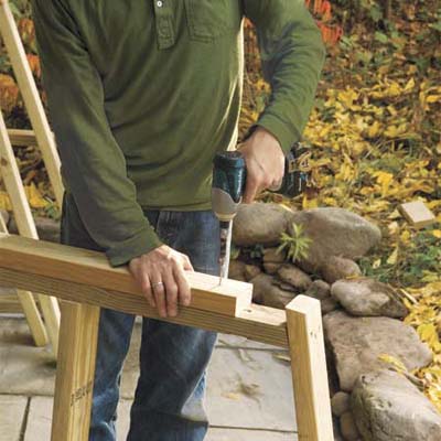 Mark Powers building front supports for his trash shed