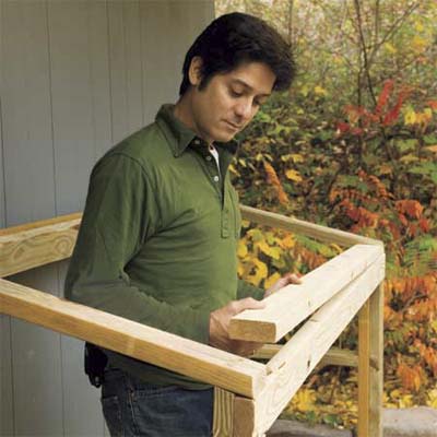 Mark Powers installing the lid support for his trash shed