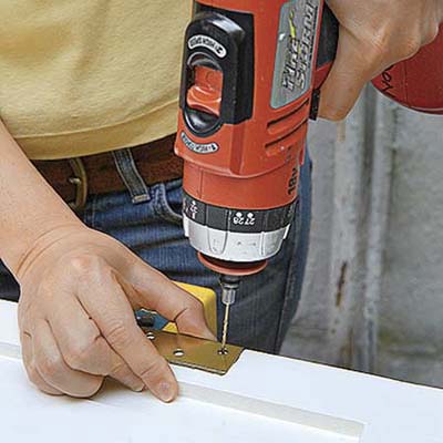 drilling screw holes to fit the hinges to the new mortises