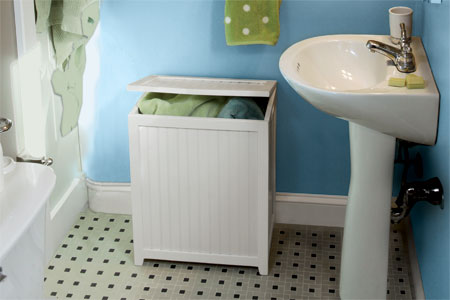 wood hamper in a blue bathroom
