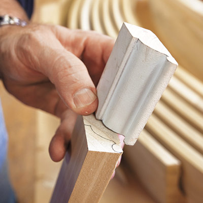 hand tracing profile of custom molding to make duplicate