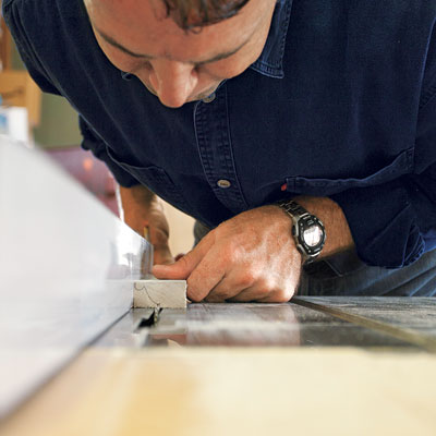 man roughing out profile of custom molding