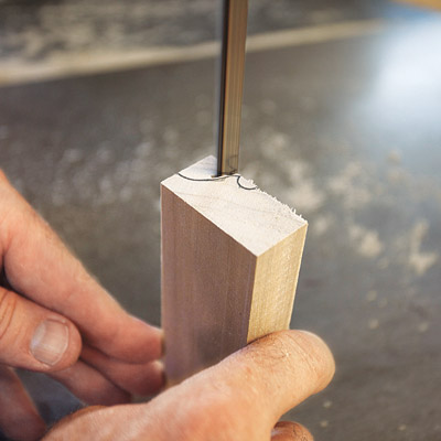 man using band saw to make custom sanding block for wood molding