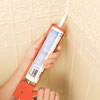applying caulk to the corner of the installed Lincrusta wainscot panels