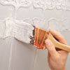 adding highlights to the painted Lincrusta wainscot panels with a dry brush
