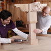 men attaching stand to poker table