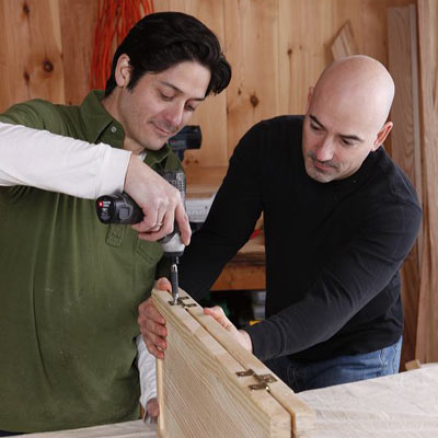 installing hinges on the bifold doors with a drill/driver