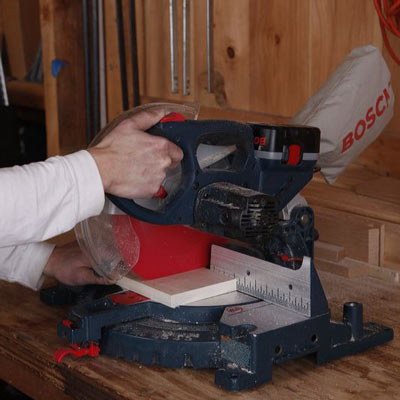 cutting a frame piece with a miter saw
