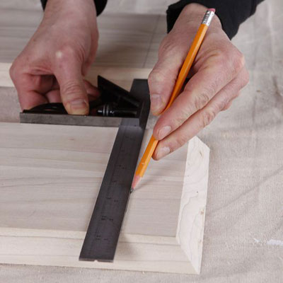 marking the side's location onto the top board with combination square and a pencil