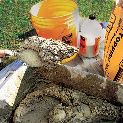 mixing up the new mortar to repair a stone walkway