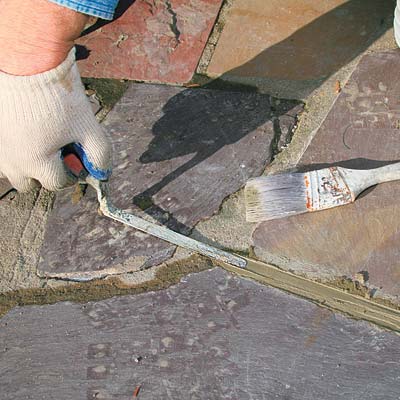 packing down mortar with a tuck-pointing trowel
