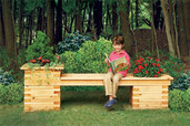 child enjoying a seat on an outdoor planter bench on a beautiful day