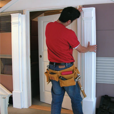 Mark Powers installs pilasters on an office cubicle