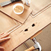 hammering in scrap wood to fill holes in a repurposed door
