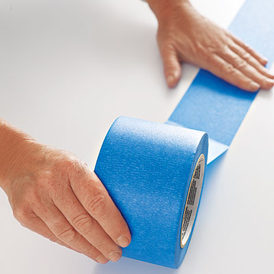 laying the first row of painter's tape on a table surface