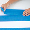 completing the first row of stripes with painter's tape as spacer