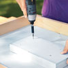 Mark Powers fastens a foam piece for the recessed area of a hypertufa table