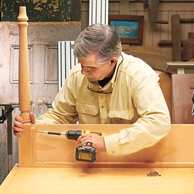 Tom Silva attaches the base to the table legs