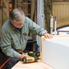 Tom Silva adds trim to the bookcase/cabinet