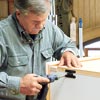 Tom Silva attaches the shutter doors to the bookcase/cabinet