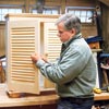 Tom Silva attaches the knobs to the shutter doors