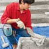 apply morter to clad concrete steps in stone