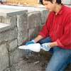 grout the stones to clad concrete steps in stone